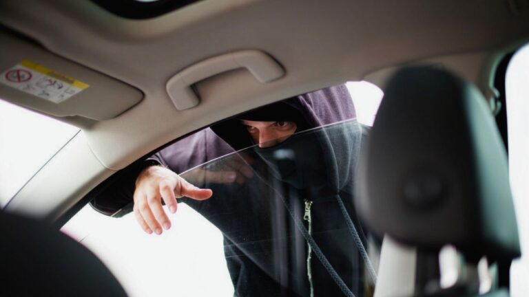 Driver says a kid approached his car at a red light asking for 50 cents — and then two men hit the doors from the other side