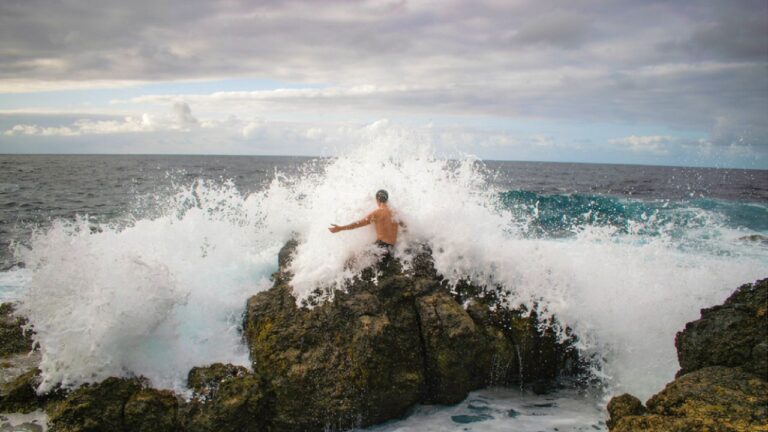Fisherman says he was alone on the point of a jetty at night when a rogue wave knocked him into the ocean — and the current carried him a mile down the beach before he could get out