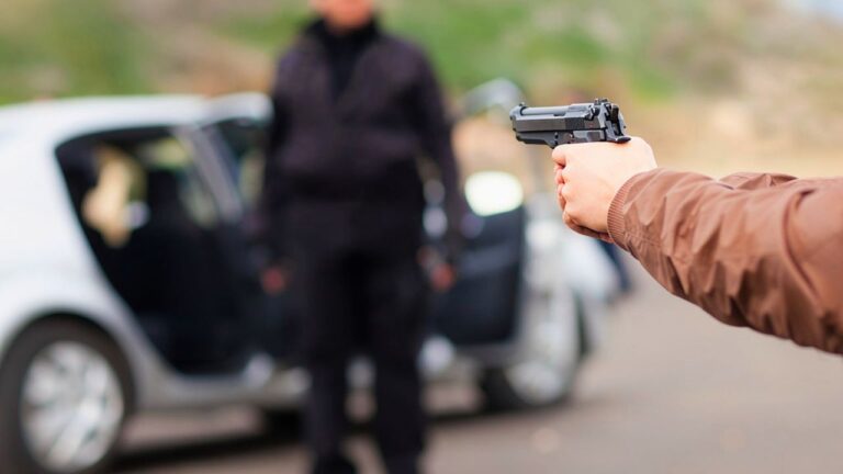 Driver says he looked out from the gas-station counter and saw two men walking up on his friend with knives and zip ties — so he ran outside and drew before they could get any closer