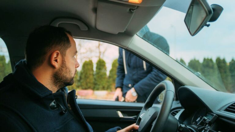 Driver says a stranger at a gas station kept edging toward his car door — and he was already clearing his shirt before his wife made it back outside