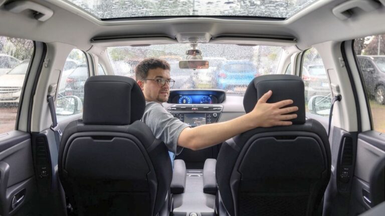 Driver says he jumped into his car in a Walgreens parking lot during a downpour — and then realized there was already a stranger sitting in the back seat