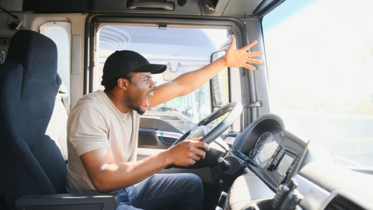 Driver says a man stepped off the sidewalk into the middle of a four-way stop with a knife — and the crowd behind him made it feel like the whole thing had been set up