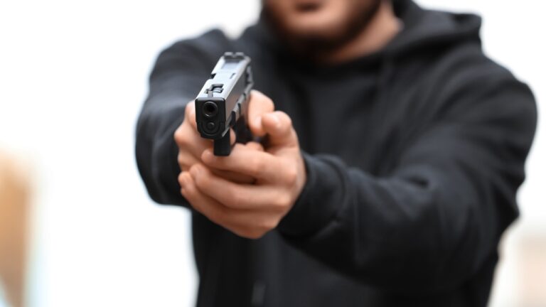 Man says he came home and found an armed burglar inside with his father — and ended up holding him at gunpoint until police arrived