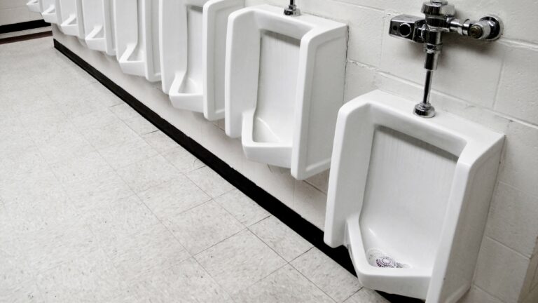 Dad says he looked up from a bathroom stall while his little boy was using the urinal — and a man in the next stall was standing on the toilet to watch him